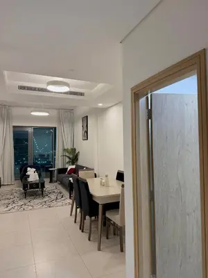 a living room with a table and chairs and a couch at Flat 1BR Business Bay the bay in Dubai