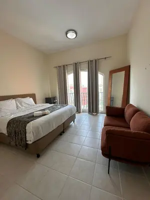 a bedroom with a bed and a couch at Executive Master bed Room With attached bathroom in Dubai