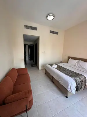 a bedroom with a bed and a couch at Executive Master bed Room With attached bathroom in Dubai