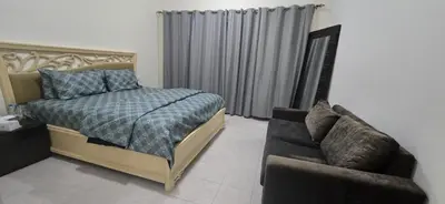 a bedroom with a bed and a couch at Luxury Master Bed Room With Attached Bathroom in Dubai