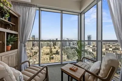 a living room with a view of the city at Nonna house Stylish 1BR and Panoramic Studio, City, Golf, Lake view in Dubai