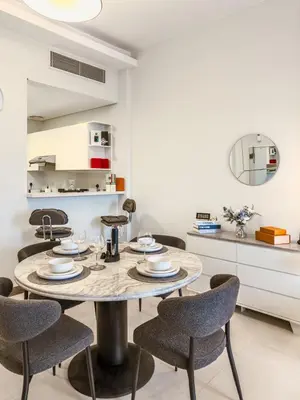 a dining room with a table and chairs at Luxury Stunning Burj Khalifa View High Floor Big Balcony Pool&Gym 1BR 80m2 in Dubai