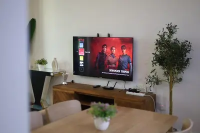 a flat screen tv sitting on top of a table at Luxury 2BHK In Marina W Rooftop Pool Man 1908 in Dubai
