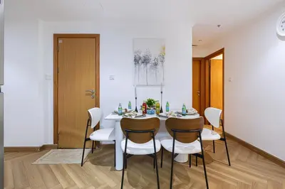 a white dining room with a white table and chairs at Lux 3 Bedroom Apt In Dubai Marina Man 2003 in Dubai