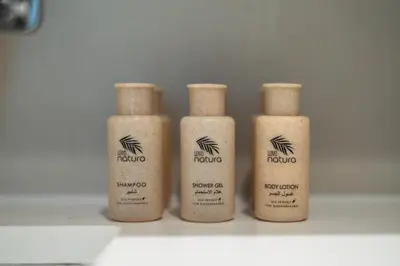 a group of four bottles of kruitiousutics sitting on a shelf at New Elegant 1BR with Balcony & Pool in Park Field in Dubai