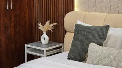 a bedroom with a bed with a vase on a table at Luxury 2BHK in Dubai Marina Escan 402 in Dubai