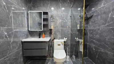 a bathroom with a toilet and a sink and a mirror at Luxury 2BHK in Dubai Marina Escan 402 in Dubai