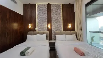 two beds in a hotel room with towels on them at Luxury 2BHK in Dubai Marina Escan 402 in Dubai