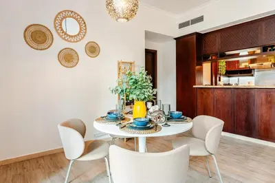 a dining room with a table and chairs at Cozy 1BR Near Burj Khalifa and Dubai Mall in Dubai