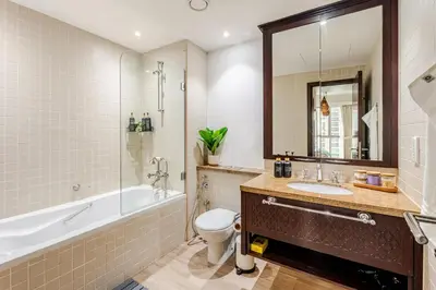a bathroom with a tub and a toilet and a sink at Cozy 1BR Near Burj Khalifa and Dubai Mall in Dubai