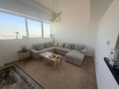 a living room with a couch and a table at Stunning Furnished 3-Bedroom Apartment in Dubai