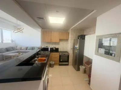 a kitchen with a sink and a stove top oven at Stunning Furnished 3-Bedroom Apartment in Dubai