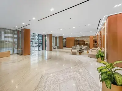 a lobby of a building with chairs and plants at New! Lovely 1BR with Balcony & Pool in Binghatti Orchid in Dubai
