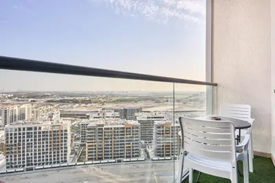 a balcony with a table and chairs and a view at STAY BY LATINEM Luxury 1BR plus study Holiday Home W2405 in Dubai