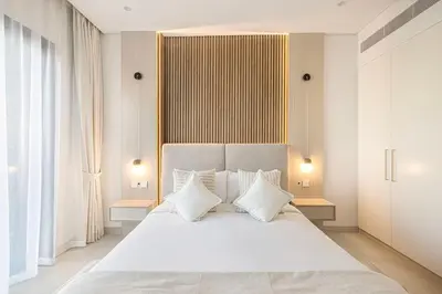 a bedroom with a large white bed with white pillows at Daniels 1BR at Viridian by Central Park, City Walk in Dubai