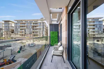 a balcony with chairs and a view of a building at Daniels 1BR at Viridian by Central Park, City Walk in Dubai