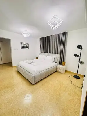 a bedroom with a large white bed in a room at Luxe Villa Rooms in Dubai