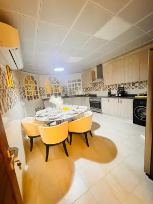 a kitchen with a table and chairs in a room at Luxe Villa Rooms in Dubai