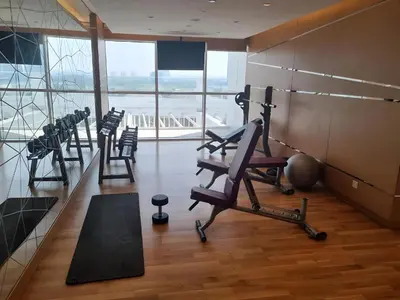 a gym with treadmills and exercise equipment in a building at Studio in Dubai