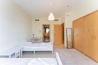 a bedroom with two beds and a hallway at HAVN - 2 bedroom in Marina with Dubai Marina View in Dubai