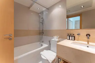 a bathroom with a tub and a toilet and a sink at HAVN - 2 bedroom in Marina with Dubai Marina View in Dubai