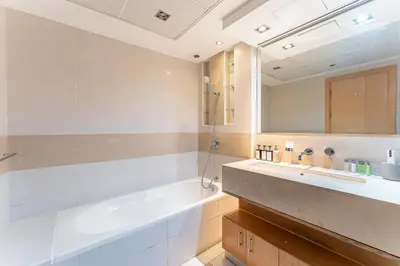 a bathroom with a tub and a sink and a mirror at HAVN - 2 bedroom in Marina with Dubai Marina View in Dubai