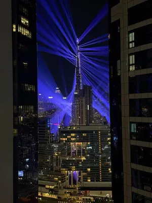 a view of a city skyline at night at Cozy 2BR in Paramount Dubai with Burj Khalifa View in Dubai