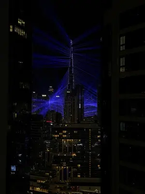 a view of a city skyline at night at Cozy 2BR in Paramount Dubai with Burj Khalifa View in Dubai
