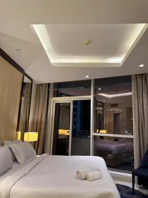 a bedroom with a bed and a large window at Spacious 2BR in DAMAC - Burj View in Dubai