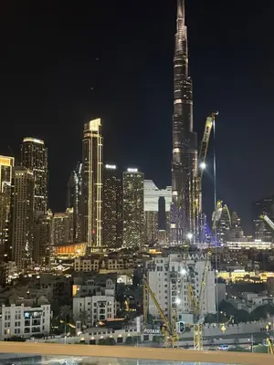 a nighttime view of a large city at night at Spacious 2BR in DAMAC - Burj View in Dubai