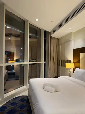 a bedroom with a large bed and a large window at Spacious 2BR in DAMAC - Burj View in Dubai