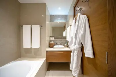 a bathroom with a bath tub and a sink at New 1BR Burj View Infinity Pool 5min Dubai mall in Dubai