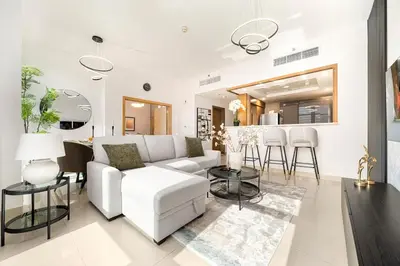 a living room with a white couch and a table at New 1BR Burj View Infinity Pool 5min Dubai mall in Dubai
