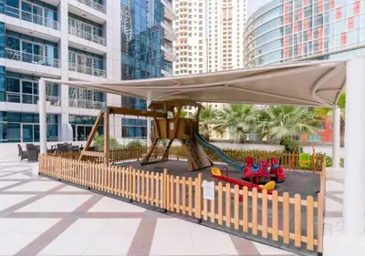a playground with a canopy and slide in a building at Werova- Waterfront 1-Bedroom Apartment Furnished in Dubai