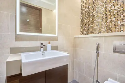 a bathroom with a white sink and a mirror at STAY BY LATINEM Luxury 2BR Holiday Home G5- 5812 near Burj Khalifa in Dubai
