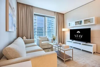 a living room with a couch and a tv at STAY BY LATINEM Luxury 2BR Holiday Home G5- 5812 near Burj Khalifa in Dubai