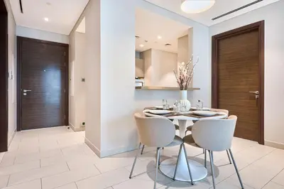 a dining room with a table and chairs at STAY BY LATINEM Luxury 2BR Holiday Home G5- 5812 near Burj Khalifa in Dubai