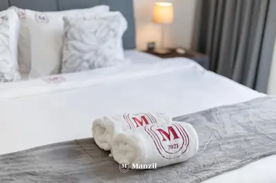 a hotel room with two towels on a bed at 1BR Urban Living near Downtown in District One in Dubai