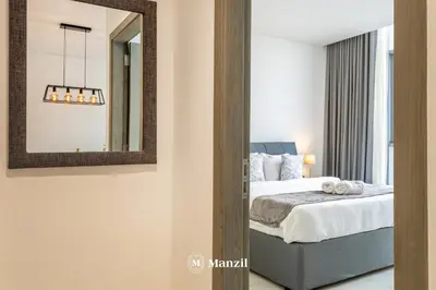 a bedroom with a bed and a mirror at 1BR Urban Living near Downtown in District One in Dubai