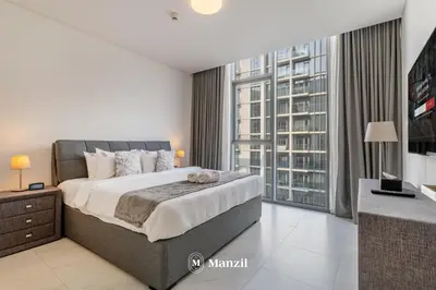 a bedroom with a large bed and a large window at 1BR Urban Living near Downtown in District One in Dubai