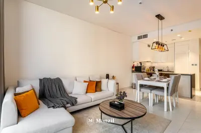 a living room with a couch and a table at 1BR Urban Living near Downtown in District One in Dubai