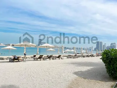 a beach with chairs and umbrellas and the word intention at Beachfront Escape Sea-View Balcony Palm Jumeirah in Dubai