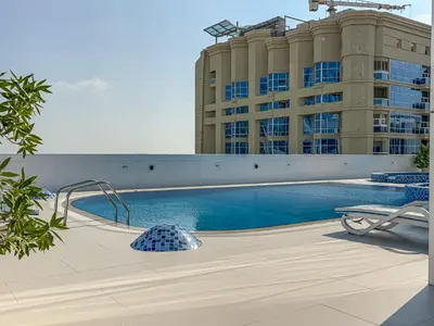 a swimming pool in front of a building at Stylish JLT Studio in Dubai