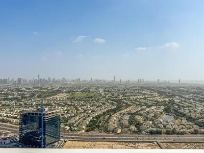 an aerial view of a city with a tall building at Stylish JLT Studio in Dubai