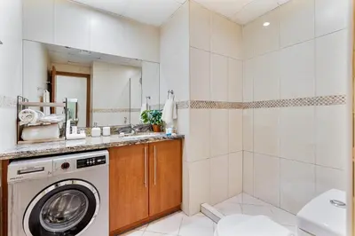 a bathroom with a washing machine and a shower at Stylish JLT Studio in Dubai