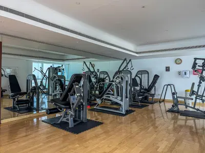 a gym with several treadmills and elliptical machines at Stylish JLT Studio in Dubai