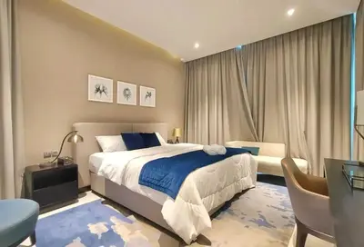a bedroom with a king sized bed and a desk at Amazing Canal View 2 BR sweet retreat in Dubai