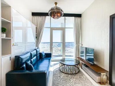 a living room with a blue couch and a table at Chic Urban Escape 1BR Sleeps- 4 In Bayz-18 in Dubai