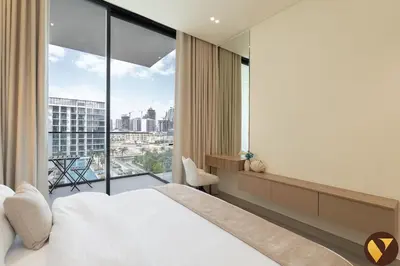 a bedroom with a bed and a large window at Vogue JVC Binghatti Phoenix near Circle Mall, One Bedroom Apartment with Balcony and Access to all Amenities in Dubai