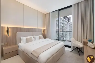 a bedroom with a large white bed and a window at Vogue JVC Binghatti Phoenix near Circle Mall, One Bedroom Apartment with Balcony and Access to all Amenities in Dubai